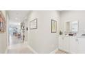 Inviting hallway with decorative accents, leading to various rooms in the home at 9970 Cross River Trl, Parrish, FL 34219