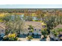 Aerial view of townhomes overlooking a pond and golf course in a lush, green community at 6748 Fairview Ter # 4-202, Bradenton, FL 34203
