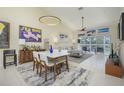 Bright and airy living room/dining room combo with tile floors, ceiling fan, and high ceilings at 6748 Fairview Ter # 4-202, Bradenton, FL 34203