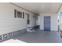 Covered carport area providing convenient access to the home with a door at 1005 45Th E Ave, Ellenton, FL 34222