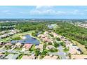 A beautiful aerial view of a residential neighborhood that is built around a small lake and golf course at 1311 Tuscany Blvd, Venice, FL 34292