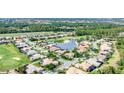 Beautiful aerial view of a residential neighborhood that is built around a small lake and golf course at 1311 Tuscany Blvd, Venice, FL 34292