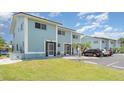 Two-story condo featuring a well-maintained lawn, a private entrance, and convenient parking at 1424 Mediterranean Dr # 112, Punta Gorda, FL 33950