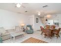 Open-concept living room and dining area with tile flooring and comfortable furnishings at 1424 Mediterranean Dr # 112, Punta Gorda, FL 33950