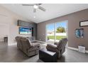 Bright living space with comfortable seating, an entertainment center, and sliding glass doors to the backyard at 1606 22Nd W Ave, Palmetto, FL 34221