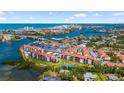 Expansive aerial view of waterfront condos, a tennis court, and beautiful blue waterways and beaches at 1624 Stickney Point Rd # 204, Sarasota, FL 34231