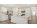 Bright kitchen with stainless steel appliances, white cabinets, and quartz countertops with a center island at 17119 Barnwood Pl, Bradenton, FL 34211