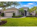 Charming single-story home boasts a lush lawn, mature landscaping, and a welcoming front porch area at 224 Dahlia Ct, Bradenton, FL 34212