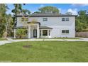 Front exterior of a two-story white home featuring a well-maintained lawn and front yard at 2655 Bay St, Sarasota, FL 34237
