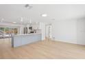 Open-concept kitchen and living area featuring sleek countertops, modern appliances, and wood flooring at 2655 Bay St, Sarasota, FL 34237