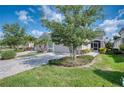Well-manicured lawn and landscaping enhance the curb appeal of this charming single Gathering home at 2945 Trustee Ave, Sarasota, FL 34243