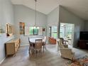 Open-concept space combining dining and living areas with views to the sunroom at 3002 Sail Pointe Cir # 1B, Venice, FL 34293