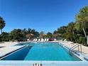 Enjoy a refreshing swim in the pristine community pool, enhanced by tropical foliage and convenient sun shelters at 3002 Sail Pointe Cir # 1B, Venice, FL 34293