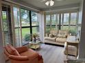 Relaxing sunroom filled with natural light, showcasing comfortable seating and views of the landscaped surroundings at 3002 Sail Pointe Cir # 1B, Venice, FL 34293