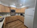 Functional kitchen featuring wood cabinets, modern appliances, and ample countertop space at 3105 Gulfgate Dr, Sarasota, FL 34231