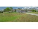Spacious home featuring a well-maintained lawn and a two-car garage, ideal for Gathering living at 4037 Wooley Ave, North Port, FL 34287