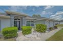 Attractive single-Gathering home with neat landscaping, decorative stone, and a welcoming front entrance at 4037 Wooley Ave, North Port, FL 34287