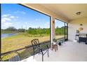 Relaxing screened patio with serene views of the pond and lush greenery at 4119 Mossy Limb Ct, Palmetto, FL 34221