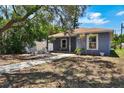 Inviting home with a walkway leading to the entrance and a relaxing outdoor seating area with a fire pit at 4542 19Th S Ave, St Petersburg, FL 33711