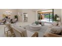 Bright living room with neutral tones, stylish furniture, and seamless access to the outdoor pool area at 4625 Deer Creek Blvd, Sarasota, FL 34238