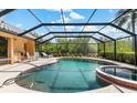 Inviting screened pool and spa with ample deck space for entertaining and relaxing in the Florida sunshine at 4625 Deer Creek Blvd, Sarasota, FL 34238