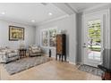 Bright living room featuring neutral paint, tile flooring, plantation shutters, and comfortable seating at 4712 Charles Partin Dr, Parrish, FL 34219