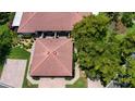 Aerial view of the home with its tile roof, green lawn, brick driveway and mature trees at 4812 Kestral Park Cir # 20, Sarasota, FL 34231