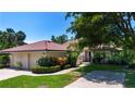 Beautiful home featuring a red tile roof, an attached garage, and mature trees at 4812 Kestral Park Cir # 20, Sarasota, FL 34231