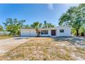 Inviting single-story home with a two-car garage, clean white exterior, and a neatly maintained yard at 4907 4Th Avenue Nw Cir, Bradenton, FL 34209