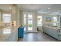 Light-filled entryway showcasing tile floors, neutral walls, and an open view to the kitchen and living area at 5301 Bartolomeo St, Sarasota, FL 34238