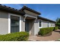 Inviting home entrance with meticulously maintained shrubs and a brick walkway at 5301 Bartolomeo St, Sarasota, FL 34238