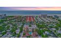 Breathtaking aerial view of a condo community near a beach with beautiful trees and landscaping at 6157 Midnight Pass Rd # E65, Sarasota, FL 34242
