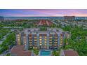 Stunning aerial view of a condo building with a pool and close proximity to the beach at 6157 Midnight Pass Rd # E65, Sarasota, FL 34242