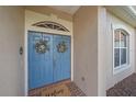 Elegant double front door adorned with floral wreaths, creating a warm and inviting entrance at 6408 Rookery Cir, Bradenton, FL 34203
