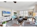 Cozy living room with stylish furniture, modern entertainment center, and plantation shutters at 6415 Midnight Pass Rd # 710, Sarasota, FL 34242