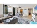 Inviting living room area with a comfortable sofa, dining table, and access to the balcony at 6415 Midnight Pass Rd # 710, Sarasota, FL 34242