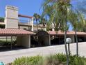 Exterior view of the community with covered parking and lush tropical landscaping at 6430 Sun Eagle Ln # 203, Bradenton, FL 34210