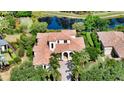 Gorgeous home with a red tile roof, lush greenery, and a brick driveway at 8016 Bounty Ln, Bradenton, FL 34202
