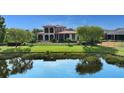Beautiful backyard featuring a pond view, mature trees, and a wrought iron fence at 8016 Bounty Ln, Bradenton, FL 34202