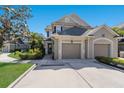 Two-story home featuring a two-car garage and an additional single-car garage at 8073 Tybee Ct, University Park, FL 34201