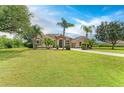 Beautiful single-Gathering home with a lush green lawn, mature trees, and inviting curb appeal at 8103 Snowy Egret Pl, Bradenton, FL 34202
