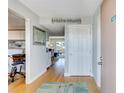 Bright entryway with wood floors leading into living area at 845 Benjamin Franklin Dr # 302, Sarasota, FL 34236