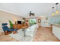 Inviting living room featuring tile floors, a comfortable sofa, and a slider to the lanai at 850 S Tamiami Trl # 431, Sarasota, FL 34236