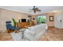 Cozy living room with tile flooring, plush white sofa, and a view of the lanai at 850 S Tamiami Trl # 431, Sarasota, FL 34236