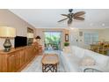 Bright living room with sliding glass doors to balcony, comfortable seating, and tile floors at 850 S Tamiami Trl # 431, Sarasota, FL 34236
