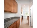 Well-designed kitchen area with granite countertops and ample wood cabinet storage at 10171 Milky Way Cir, Sarasota, FL 34241