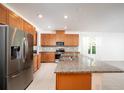 Spacious kitchen with stainless steel appliances, granite countertops, and wooden cabinets at 10171 Milky Way Cir, Sarasota, FL 34241