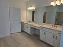 Beautiful primary bathroom featuring double vanity, walk-in closet and linen cabinets at 1591 Laurel Brook Ln, Port Charlotte, FL 33953