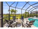 Inviting screened-in pool area with a fire pit and comfortable seating, perfect for outdoor entertaining at 16226 Hidden Oak Loop, Lakewood Ranch, FL 34211