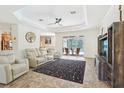 Bright living room featuring modern furnishings, stylish decor, and sliding doors to the pool at 18026 Nutcracker Rd, Weeki Wachee, FL 34614